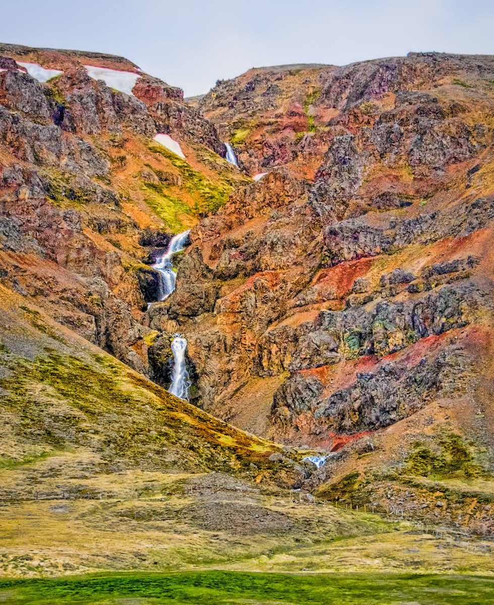This is one of many unnamed waterfalls in this area off Highway 1 southwest of Akureyri. Notice the alternating layers of basaltic lava and ash. the water cascades over the lava layers and wears away the ash layers.
