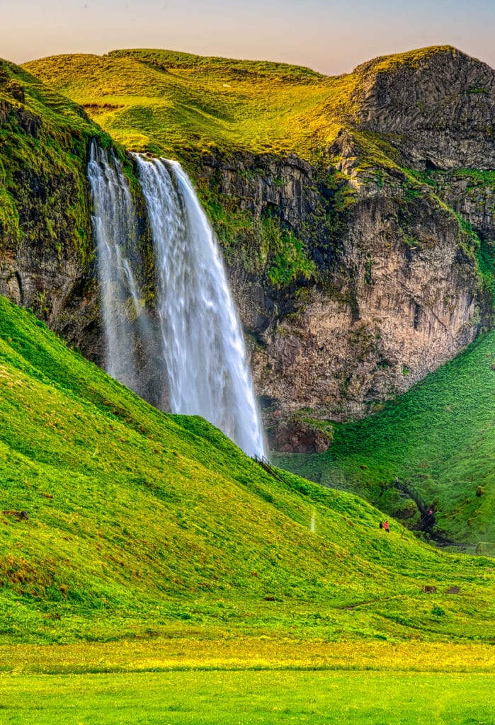 This view of Seljalandsfoss shows the path to the waterfall. The waterfall is in the South Region in Iceland right by Route 1 and the road that leads to Þórsmörk Road 249.
