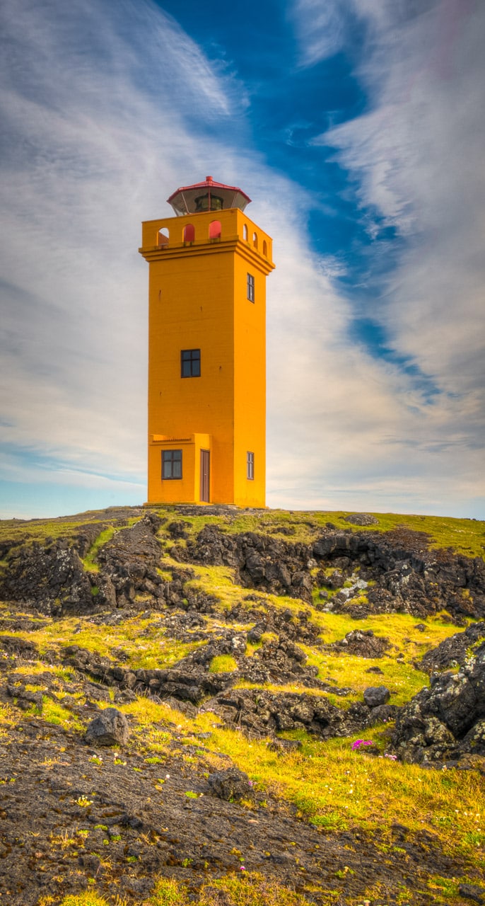 Lighthouse above the Svörtuloft cliffs at the western tip of the Snæfellsnes peninsula in Iceland.has two names. If you areon land, it is called Skálasnagaviti. If you are out at sea, it is called Svörtuloftaviti.