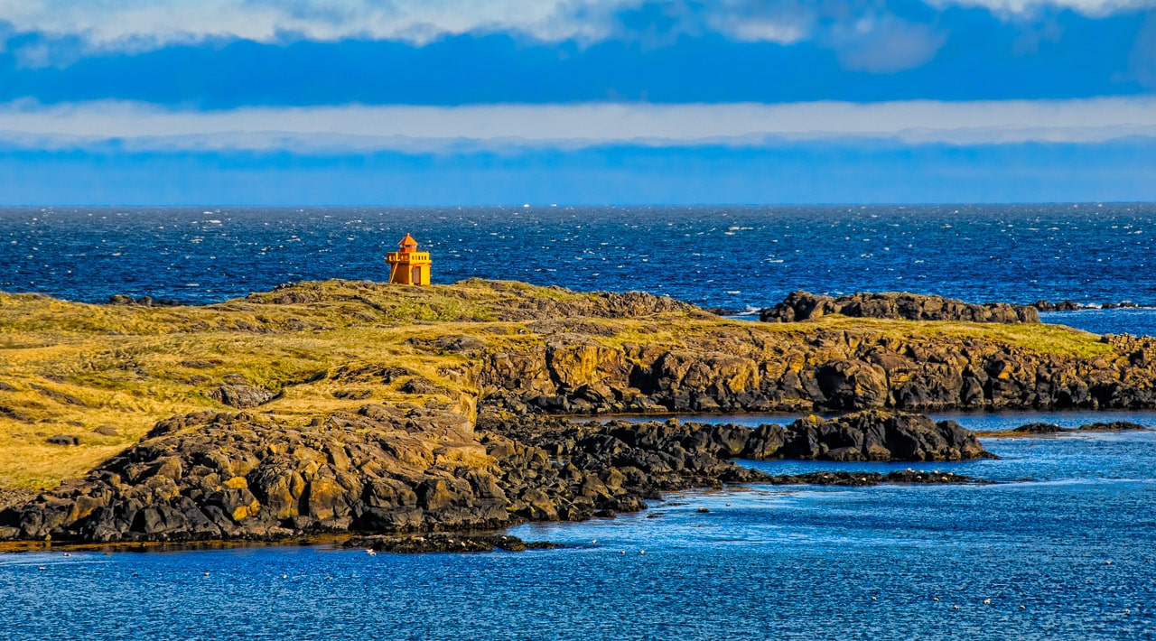A view of Æðarstein Lighthouse from the road across the fjord near the town of Djúpivogur.