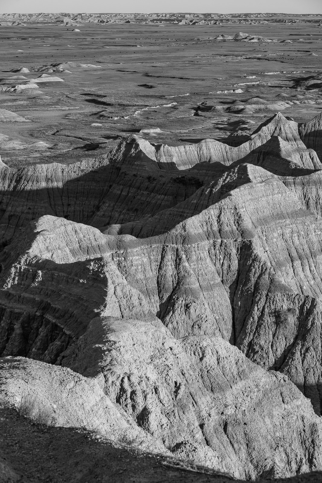This view of the erosional features is enhanced by the starkness of the black and white treatment. Without color, you can concentrate on the texture and patterns created by the relentless work of water and wind.