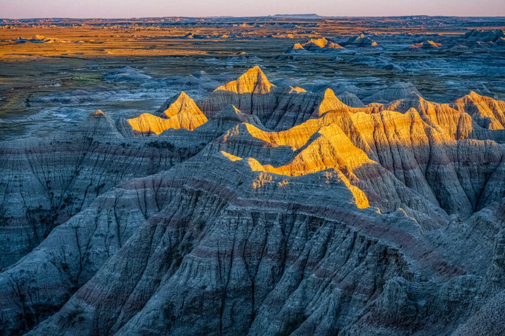 Late afternoon light catches the very tops of the hoodoos in Badlands Nationa Park, South Dakota.
