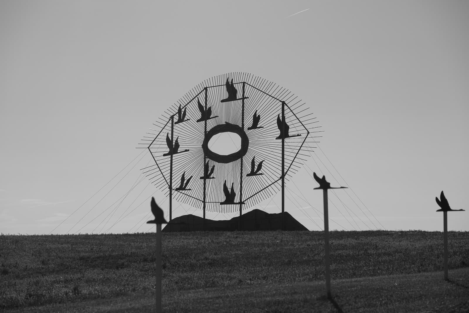 This sculpture by Gary Greff is called Geese in Flight. It is located at the Gladstone exit of I-94 and the Regent Road in North Dakota.