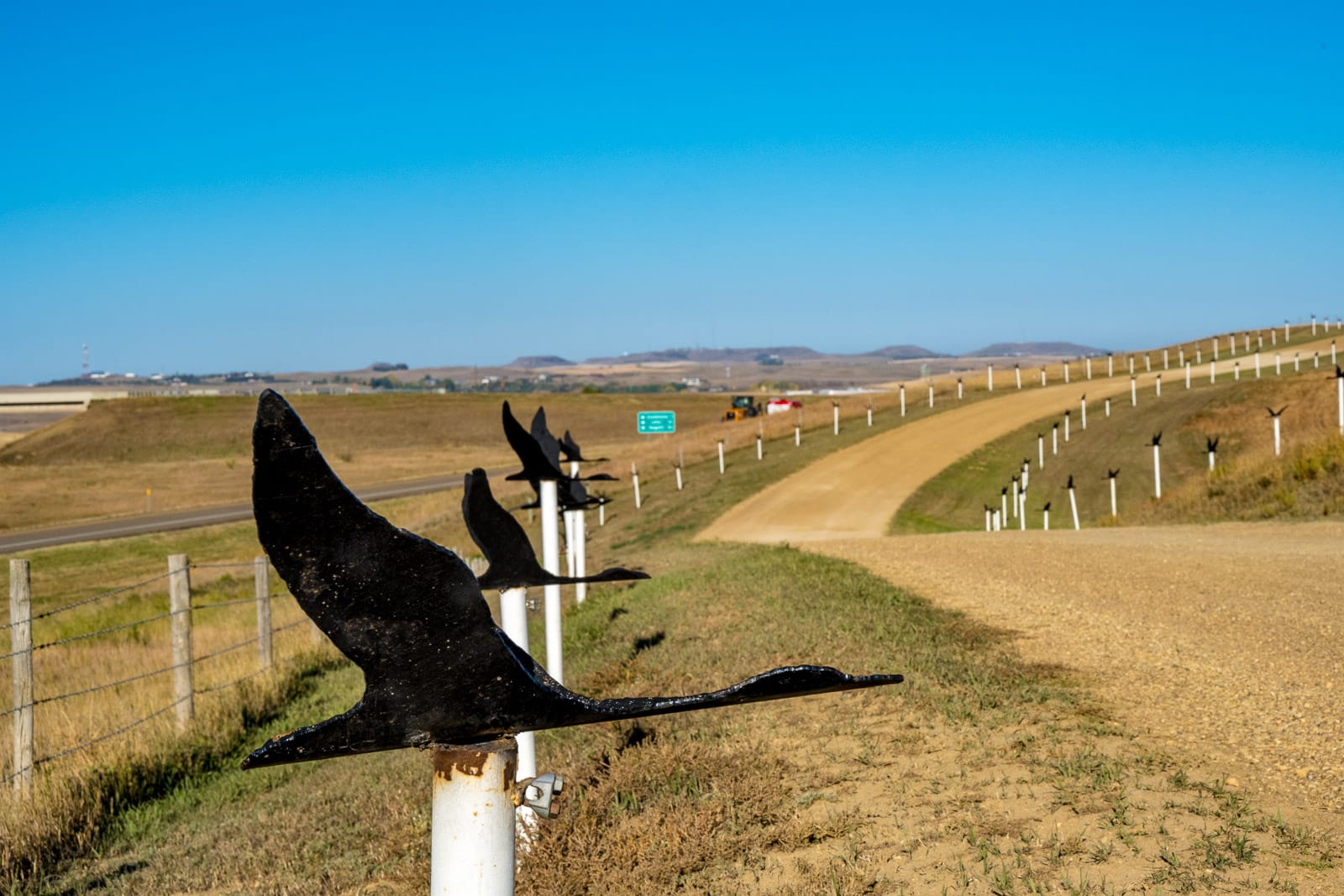 Flying geese line the road leading to the sculpture by Gary Greff called Geese in Flight. It is located at the Gladstone exit of I-94 and the Regent Road in North Dakota.