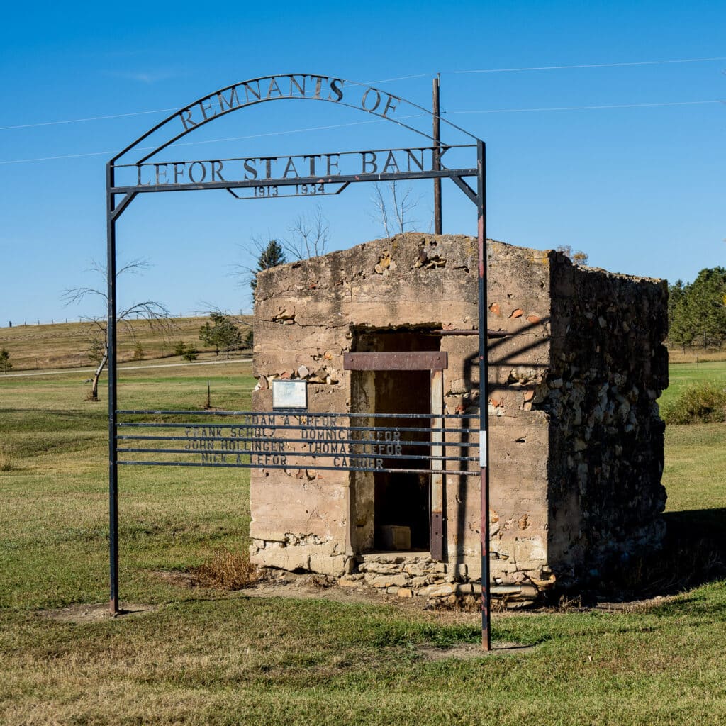 This is all that remains of the Lefore State Bank that closed during the Great Depression. The building is long gone; however, the vault still stands. The decorative iron sign was added at a later date to commemorate the bank. The vault is located along the Enchanted Highway that runs between I-94 and Regent, North Dakota.