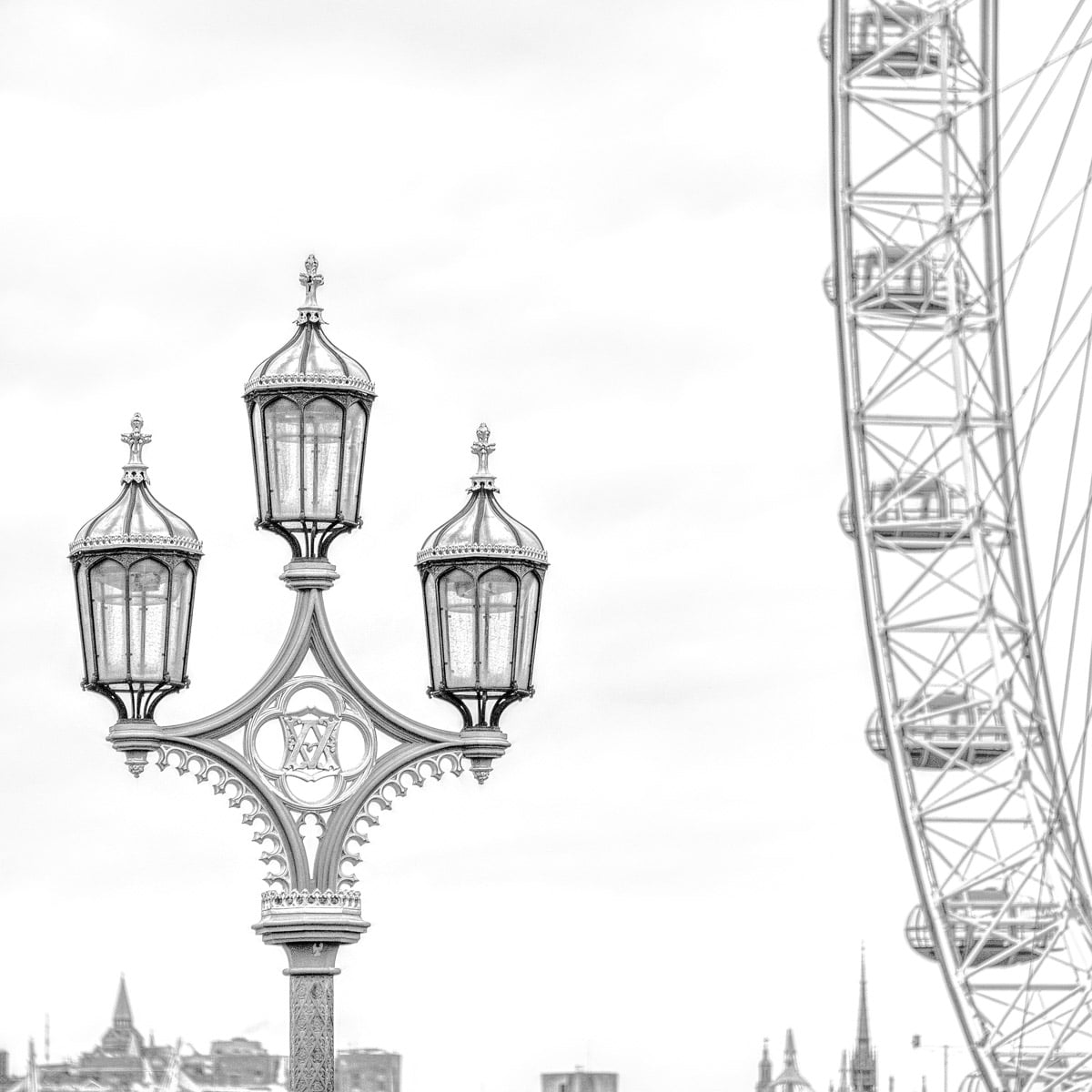 The Victorian style of this street light on the Westminster Bridge contrasts with the aggressively modern London Eye observation wheel in this high-key composition.