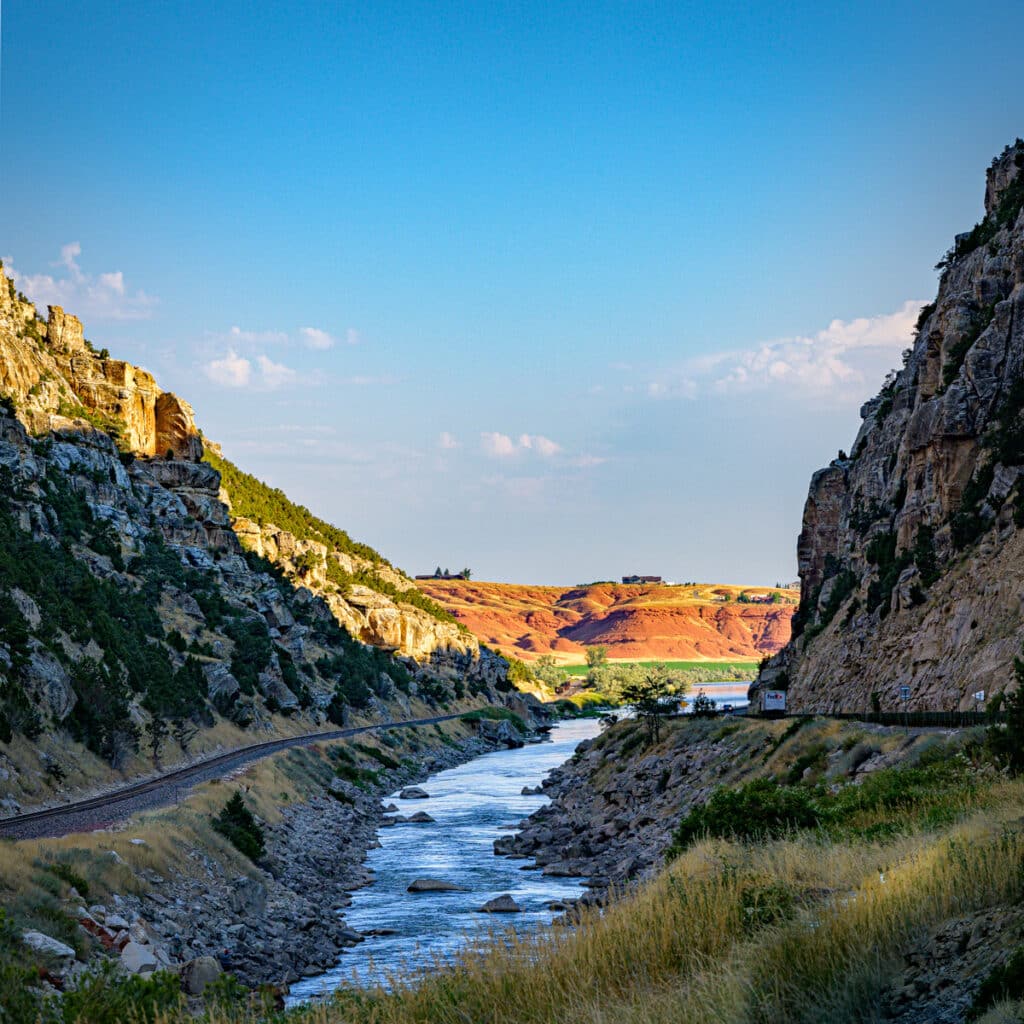 Looking north up Wind River Canyon along US Highway 20 in Wyoming, toward Thermopolis and the Wedding of the Waters. Bright red Triassic beds of the Chugwater Formation glow in the morning light.